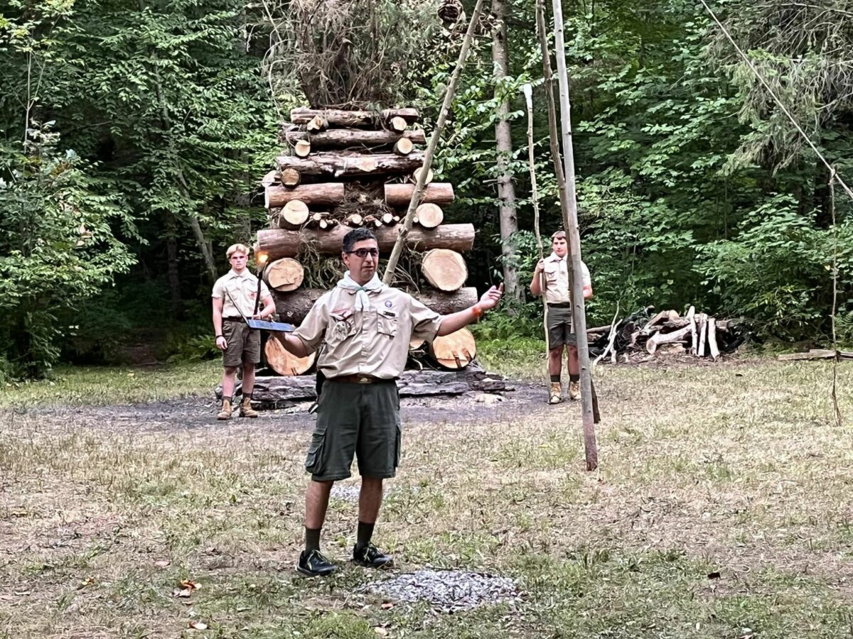 Oreland Troop 1's Scoutmaster Sergio Movsessian in front of campfire at Hawk Mountain Summer Camp 2022